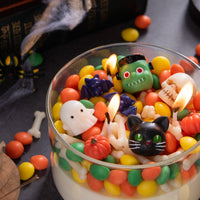 Close-up of Halloween wax melts unscented mix featuring ghost, pumpkin, cat, skull, and candy-shaped wax pieces