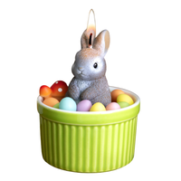 Southlake Gifts Bunny Easter Candle Bowl lit against a white background, featuring a cute gray bunny with pastel wax eggs, a handmade Easter décor candle that makes a charming seasonal gift.