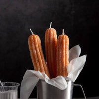 Southlake Gifts Churros Candle Set with two realistic churro-shaped taper candles, handmade holder, and gift box displayed on a marble table. A cozy dessert-inspired décor and perfect handmade gift for holiday candle lovers.