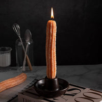 Southlake Gifts Churros Candle Set featuring two realistic churro-shaped candles, one lit and standing in the handmade holder while the other rests beside it. Cozy food-inspired holiday gift candle for home décor and dessert lovers.