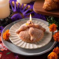 Realistic Pan de Muerto bread candle handmade with vanilla fragrance and sugar detail, Southlake Gifts Day of the Dead altar decoration.