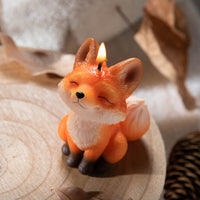 Southlake Gifts Fox Candle glowing flame. Hand-painted handmade fox design with fruity scent, whimsical décor and unique animal spirit gift candle.