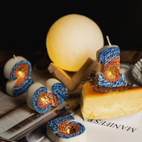 Southlake Gifts Galaxy black hole number 1 candle placed on cheesecake slice with glowing moon lamp background, a space themed birthday cake topper and handmade novelty candle.