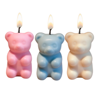 Southlake Gifts gummy bear candles lit with soft flame on white background, handmade soy wax novelty candles with hidden surprise inside, a unique gift for candle lovers.