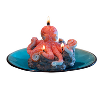 Southlake Gifts Octopus Candle lit, handmade sea-salt scented marine animal candle with rocky reef wax base on blue ceramic-style plate