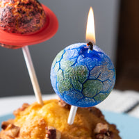 Southlake Gifts planet cake topper candle close up of Earth design with lit wick, handmade unscented candle for space theme party, realistic novelty décor and unique gift for science and space lovers