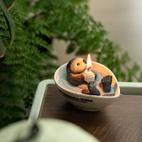 Side-view of Southlake Gifts Floating Otter Candle, highlighting realistic otter details and hand-poured soy wax water texture, an artisan handmade candle that makes a perfect holiday gift.