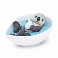 Product studio shot of the Southlake Gifts Sea Otter Candle unlit, showing detailed otter sculpture in turquoise wax pool, a handmade realistic candle for home décor and gifting.