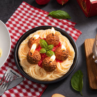 Handmade Spaghetti and Meatballs Candle by Southlake Gifts, featuring five wax meatballs, red tomato sauce, and basil leaf details, styled beside a fork and napkin — a novelty food candle perfect for gifting and kitchen décor.