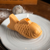 Southlake Gifts taiyaki candle placed on a ceramic plate, styled as a soft aesthetic home decor piece inspired by Japanese food desserts, bringing a cozy and creative atmosphere to everyday spaces