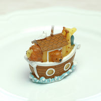 A lovely little lion, bear, giraffe and bird on the Noah's Ark Candle.