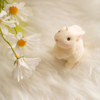 Blush bunny candle is looking up