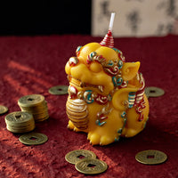 Handmade Pixiu candle by Southlake Gifts shown from the side with ancient-style Chinese coins, a detailed soy wax fortune candle inspired by Chinese culture and ideal for gifting during Lunar New Year celebrations.
