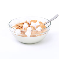 Handcrafted Cinnamon Toast Crunch Cereal Candle in clear glass bowl with wax milk and marshmallows — a minimalist artisan décor candle perfect for gifting or cozy home styling.