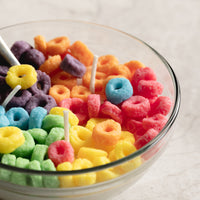 Top view of Fruit Loops Cereal Candle Bowl on a marble surface with spoon — a realistic cereal-inspired soy wax candle, perfect as a fun handmade gift for breakfast lovers and décor enthusiasts.