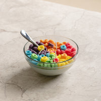 Southlake Gifts Fruit Loops Cereal Candle lit on a marble table — a whimsical hand-poured candle that looks like a real cereal bowl, ideal for gifting and brightening up modern homes.