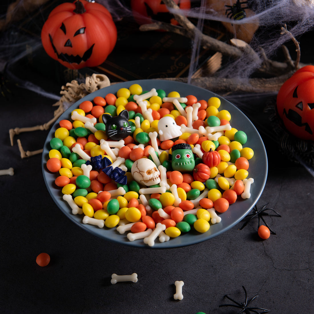 Halloween wax melts colorful spooky mix 6 oz in bowl centerpiece surrounded by cobwebs and pumpkins