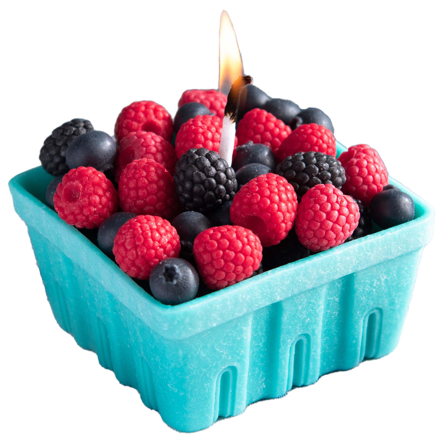 Southlake Gifts Berry Basket Candle in a white background, glowing with lifelike blueberry, raspberry, and blackberry wax melts. 