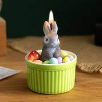 Southlake Gifts Bunny Easter Candle Bowl lit on a tabletop, featuring a wax bunny with pastel egg and mushroom details, a handmade Easter décor candle that makes a charming seasonal gift for spring celebrations.
