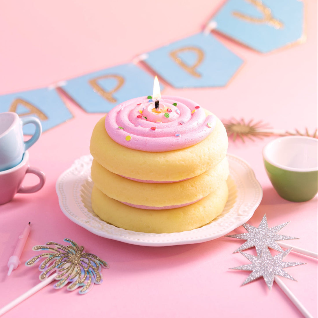 Southlake Gifts cake cookie candle styled as a birthday centerpiece on a pastel table, featuring a handmade vanilla scented cookie cake candle with pink frosting and sprinkles, perfect as a cake topper and a unique birthday gift for dessert lovers and celebration décor