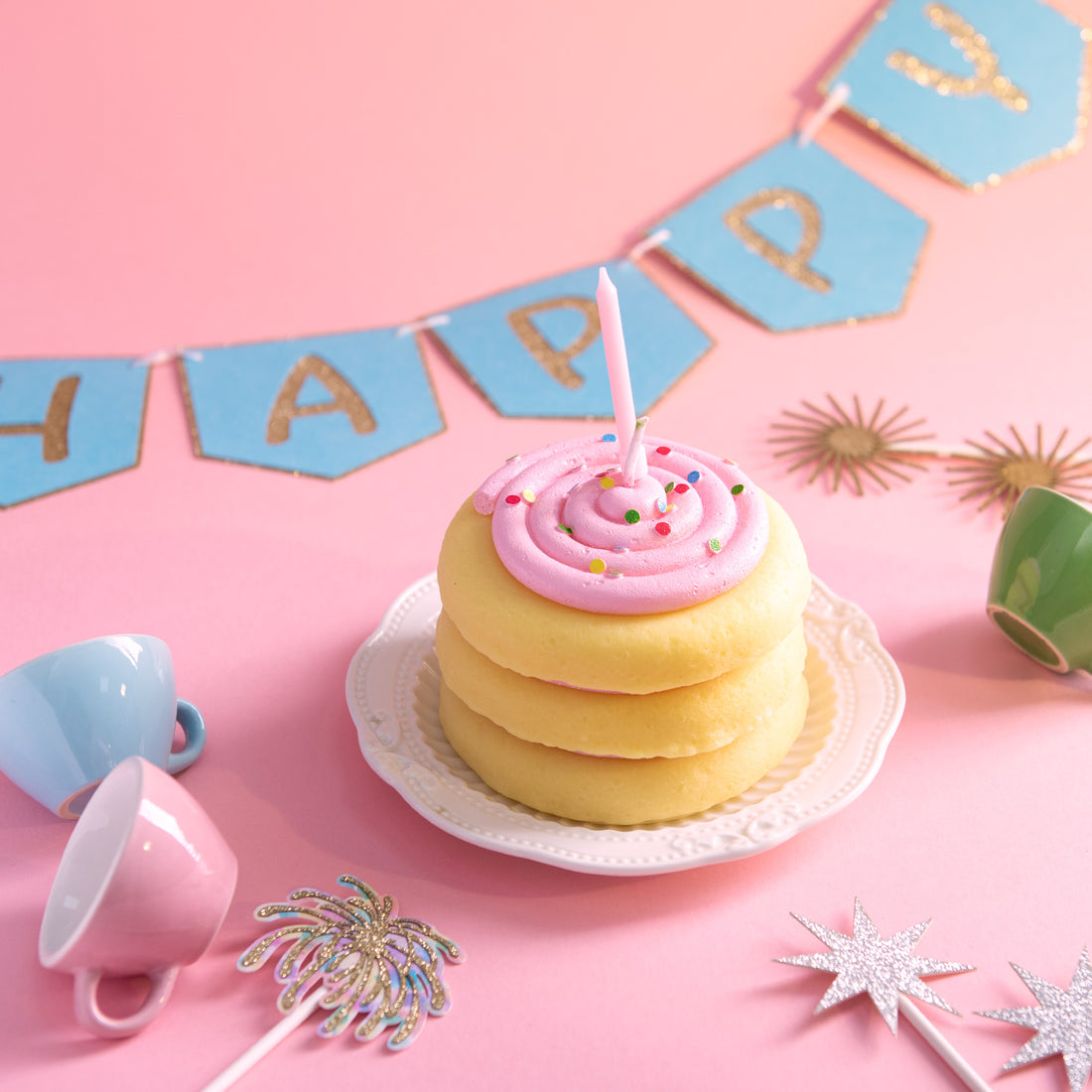Southlake Gifts cake cookie candle styled in a birthday party setup with pastel decorations and celebration banner, a handmade vanilla scented dessert candle used as a cake topper, perfect for party décor, birthday celebrations, and a fun candle gift for special occasions