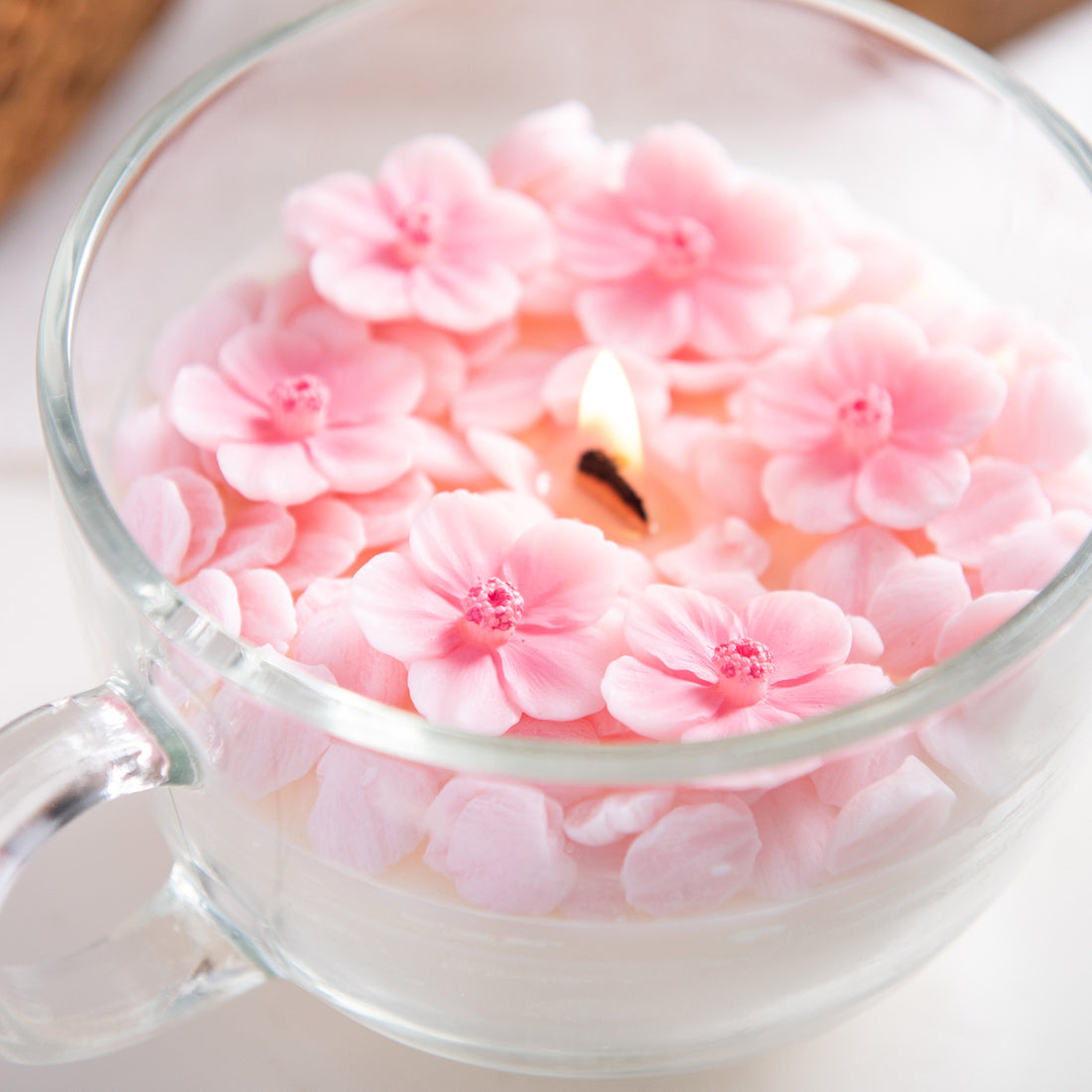 Southlake Gifts handmade sakura petal candle close up, cherry blossom wax flowers in glass cup, artisan floral candle for decorative display, spring home styling, gift for her, unique candle gift. 

