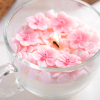 Southlake Gifts handmade sakura petal candle close up, cherry blossom wax flowers in glass cup, artisan floral candle for decorative display, spring home styling, gift for her, unique candle gift. 

