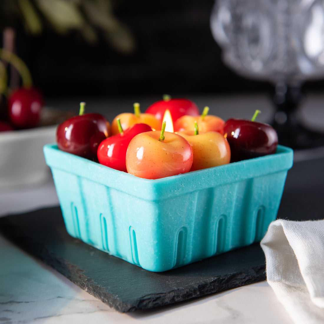 Close-up of Southlake Gifts Cherry Basket Candle filled with Rainier, red, and burgundy cherry wax melts, a cute novelty candle for fruit lovers and unique gifting.