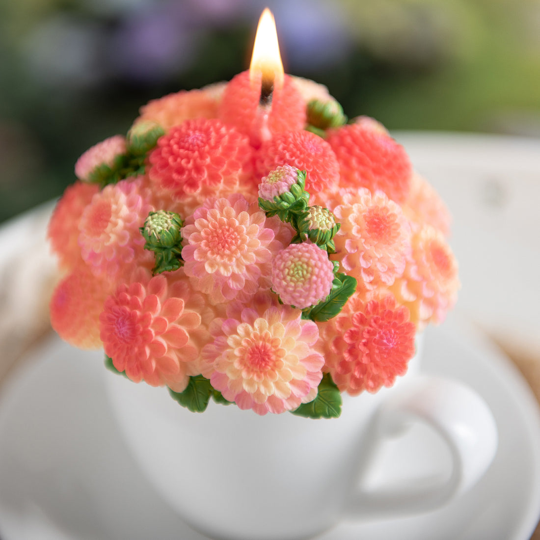 A detail look of the orange handmade Dahlia Flower Teacup Candle from Southlake Gifts