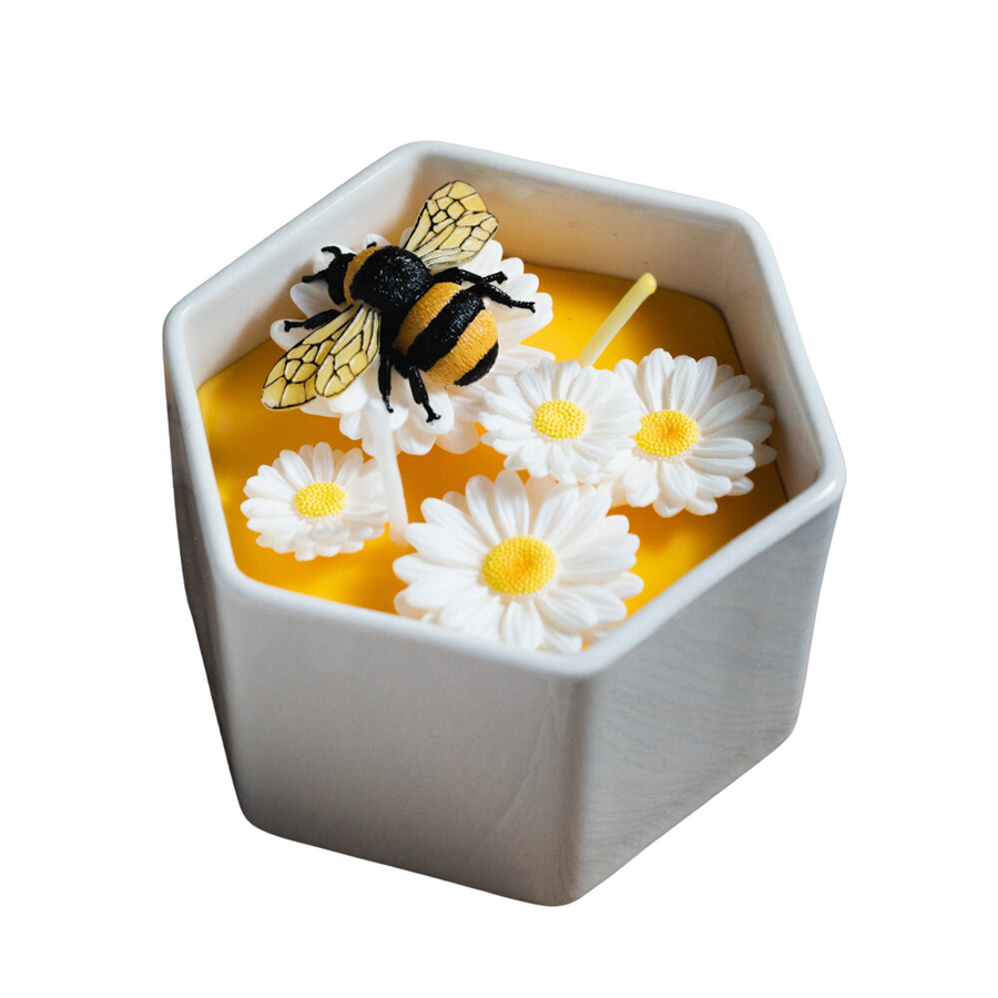 Hand-poured Daisy Beehive Candle Bowl styled with real daisies and honey jar in white background — a nature-inspired, gift-ready candle for birthdays, housewarmings, and holidays.
