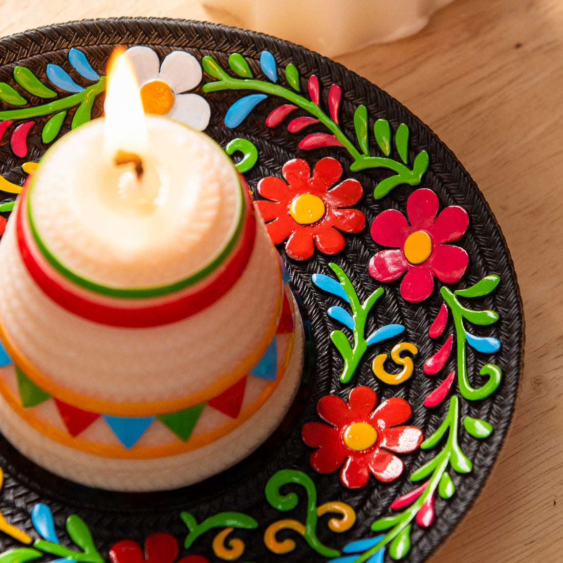 Macro detail of the Fiesta Sombrero Candle showing hand-painted floral decorations and carved woven sombrero texture, an artisan handmade candle inspired by Mexican folk art and vibrant fiesta decor, ideal as a decorative gift or celebration centerpiece.