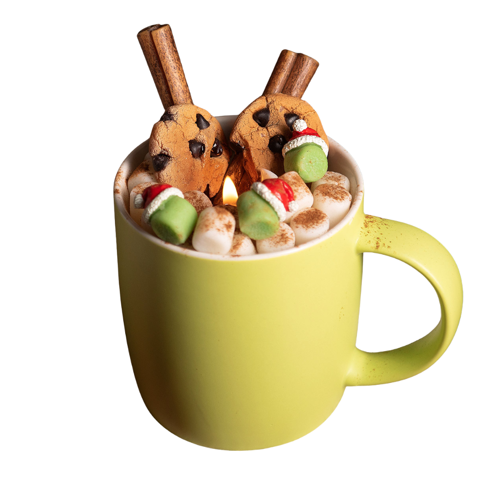 Fireside Cocoa Candle Mug on white background — featuring soy wax marshmallows, cookies, and cinnamon stick accents in reusable green ceramic mug. 