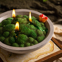 Close-up of the Forest Moss Candle by Southlake Gifts showing realistic moss-shaped wax surface and a small red mushroom accent — a unique handmade candle that makes a thoughtful home décor gift.