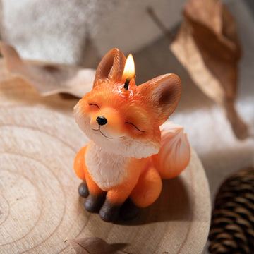 Southlake Gifts Fox Candle glowing flame. Hand-painted handmade fox design with fruity scent, whimsical décor and unique animal spirit gift candle.