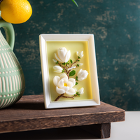 Southlake Gifts magnolia frame candle standing vertically on a shelf, showcasing a hand-carved botanical magnolia design within a sculptural picture frame candle, a unique handmade soy candle perfect for elegant décor and meaningful gifting.