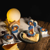 Southlake Gifts galaxy black hole number candle styled on cheesecake dessert with space themed décor and glowing moon lamp, a handmade novelty birthday candle perfect as a cake topper and a unique gift for space lovers.