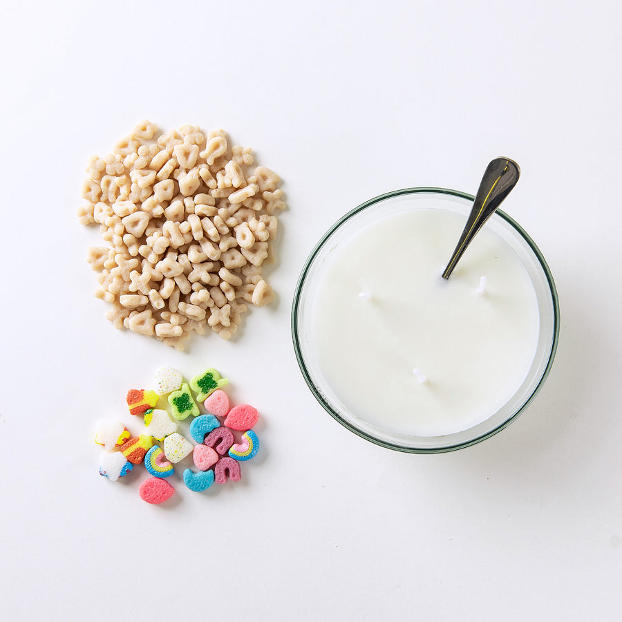 Southlake Gifts Lucky Charms Cereal Candle 2.0 shown with soy wax base and colorful cereal wax melts including rainbows, unicorns, and clovers beside the bowl — a handmade novelty candle that looks just like the real cereal, perfect for gifting to candle lovers and collectors.