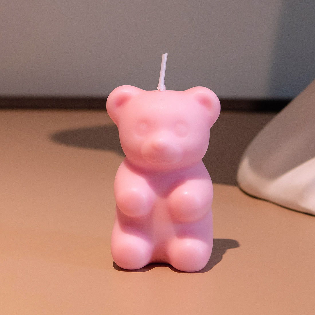 Southlake Gifts pink gummy bear candle on tabletop, handmade scented soy wax novelty candle, a cute gift idea for birthdays and home décor lovers.