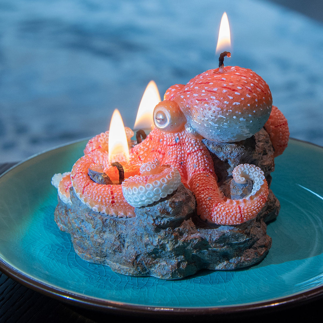Southlake Gifts Octopus Candle side view, handmade sea-salt scented marine candle with rocky reef wax base and plate display