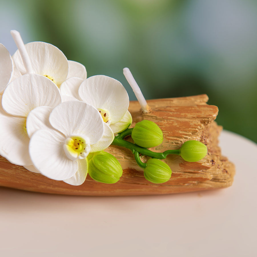 Southlake Gifts Orchid Arrangement Candle close-up of realistic white orchid petals and green buds on wood base, handmade soy wax floral décor centerpiece.