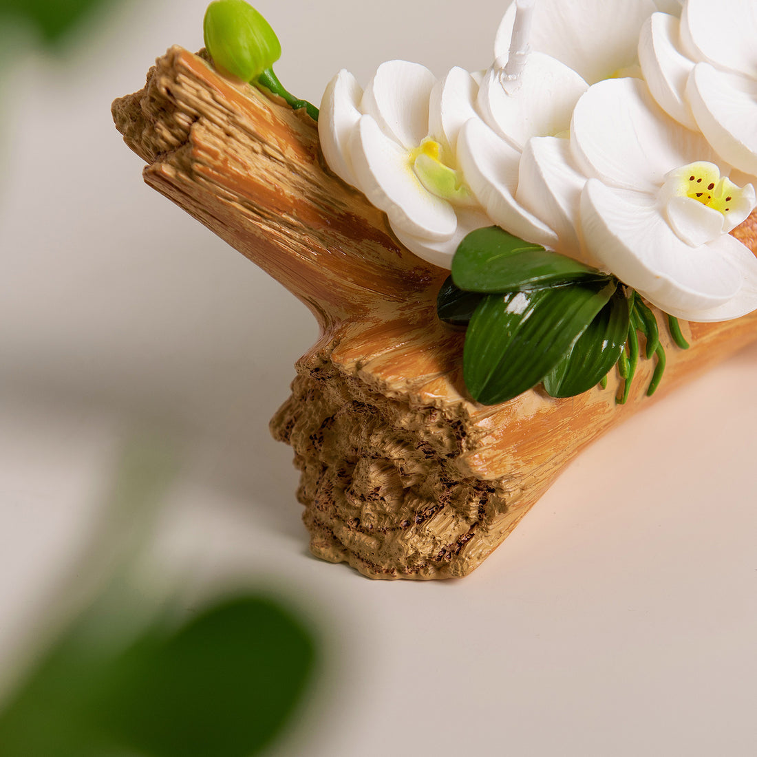 Southlake Gifts Orchid Arrangement Candle detail of sculpted orchid buds and rustic log-style wax base, artisan handmade floral candle décor piece.