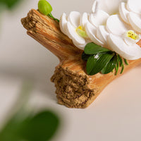 Southlake Gifts Orchid Arrangement Candle detail of sculpted orchid buds and rustic log-style wax base, artisan handmade floral candle décor piece.