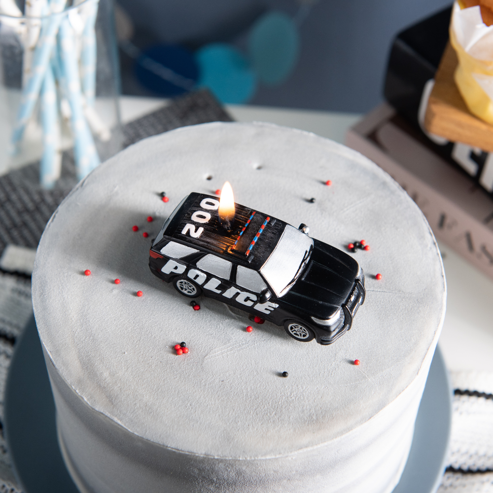 Southlake Gifts police car candle top view on cake topper, police themed birthday cake decoration idea, handmade novelty candle for kids party, patrol car candle for cop theme celebration and unique birthday gift