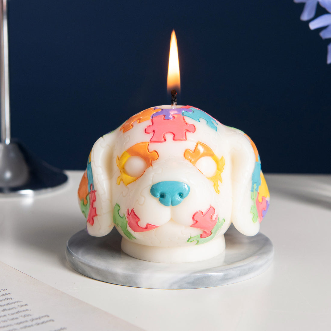 Southlake Gifts Puzzle Pup Candle burning – whimsical dog candle with multicolor puzzle design, artisan handmade gift