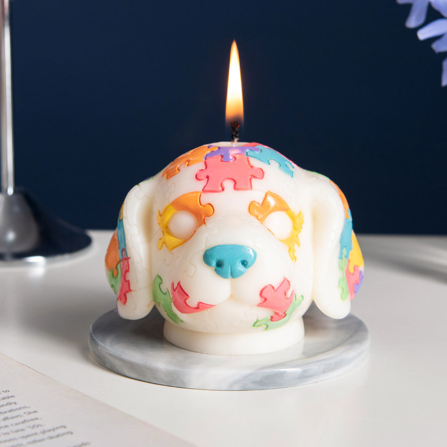 Southlake Gifts Puzzle Pup Candle burning – whimsical dog candle with multicolor puzzle design, artisan handmade gift