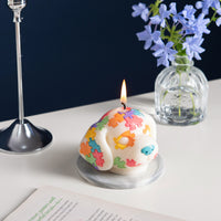 Southlake Gifts Puzzle Pup Candle is lit up in a side angle – scented pine dog-shaped candle on tabletop, unique handmade puzzle piece décor