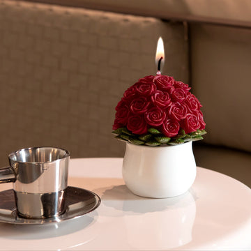 Southlake Gifts Rose Bouquet Scented Floral Candle with 33 red roses in white ceramic vase, burning on table beside coffee cup, handmade romantic candle décor