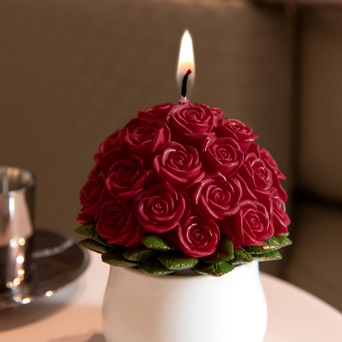 A closer look at the Southlake Gifts Rose Bouquet Candle with 33 roses lit, handcrafted red rose candle in ceramic vase for romantic home decoration