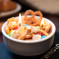 Southlake Gifts realistic Snacks Candle Bowl shown lit, highlighting colorful snack-inspired wax details in a ceramic bowl, a handcrafted décor candle designed as a unique artisan gift for candle lovers and unique home décor gifts.