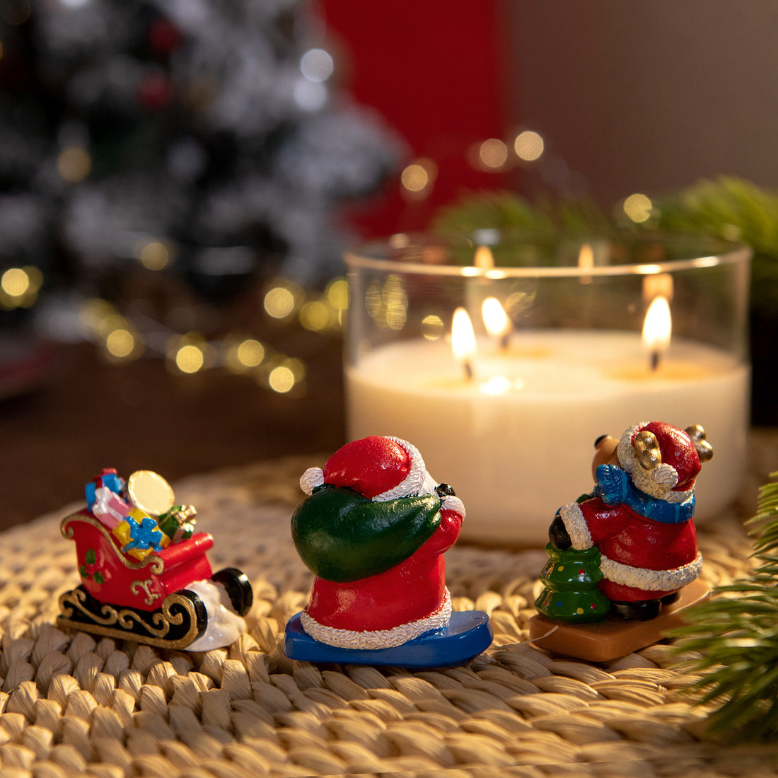 the back of the Santa and reindeer wax figures inside holiday candle, handmade Christmas décor with sleigh of gifts, floral fruit gourmand fragrance